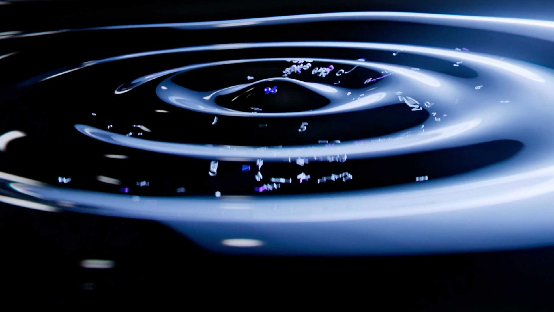 Concentric ripples move outward across a dark, liquid surface in this Ranger & Fox brand film, with illuminated numbers and symbols floating along the waves. Frame from Stash Magazine article.