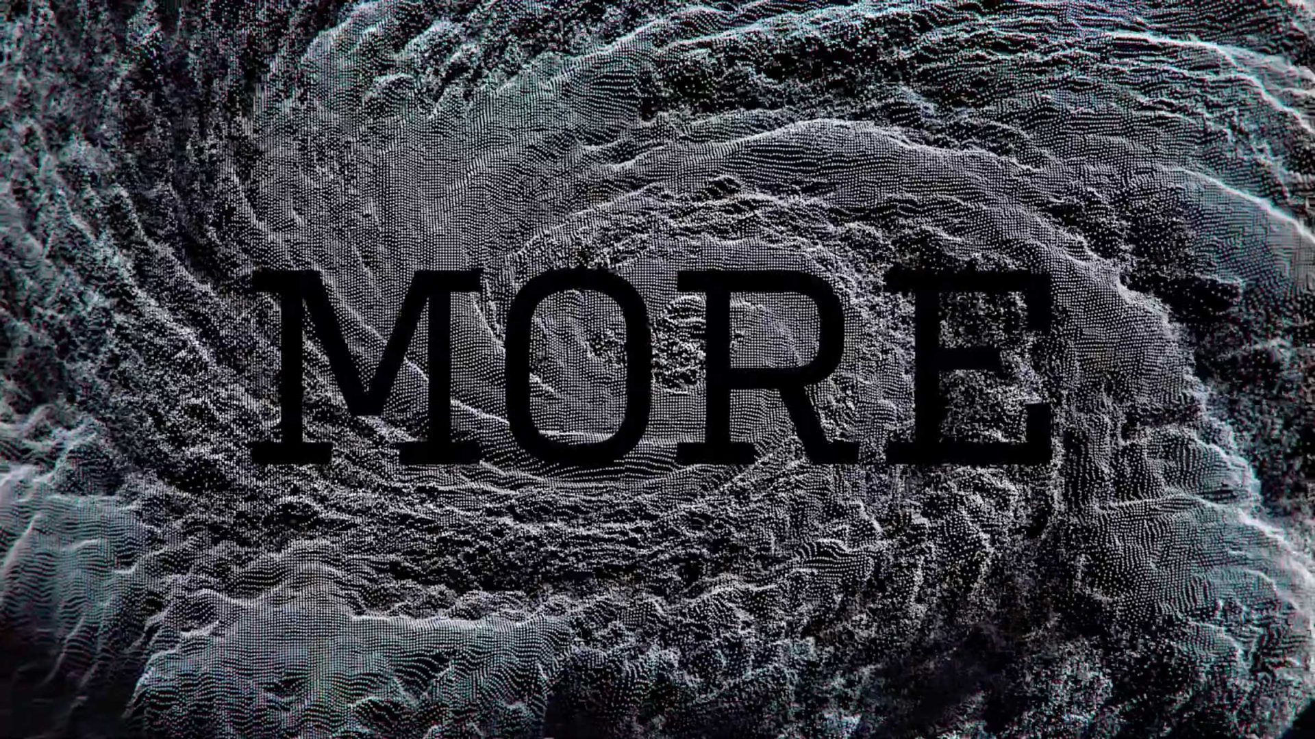 The word MORE in bold, dark, capital letters centered over a swirling, gray and white particle pattern from a Ranger & Fox brand film. Frame from Stash Magazine article.