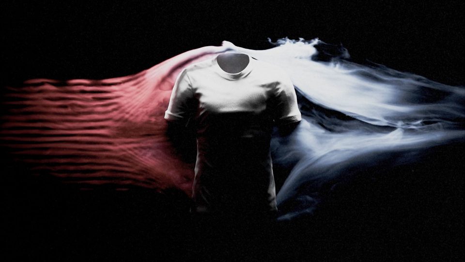 A white, headless mannequin torso wearing a t-shirt stands against a black background, with red and white smoke swirling dramatically on either side—a striking scene reminiscent of Nike Go Mad SP26 films by FutureDeluxe. Frame from Stash Magazine article.
