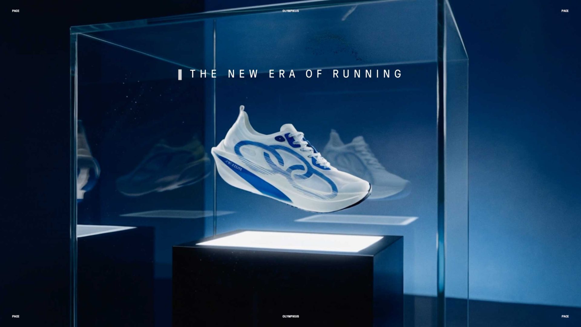 A modern white and blue Olympikus running shoe is displayed in a glass case on a pedestal, with the text The New Era of Running above it, set against a blue background—ready to set the pace for tomorrow. Frame from Stash Magazine article.