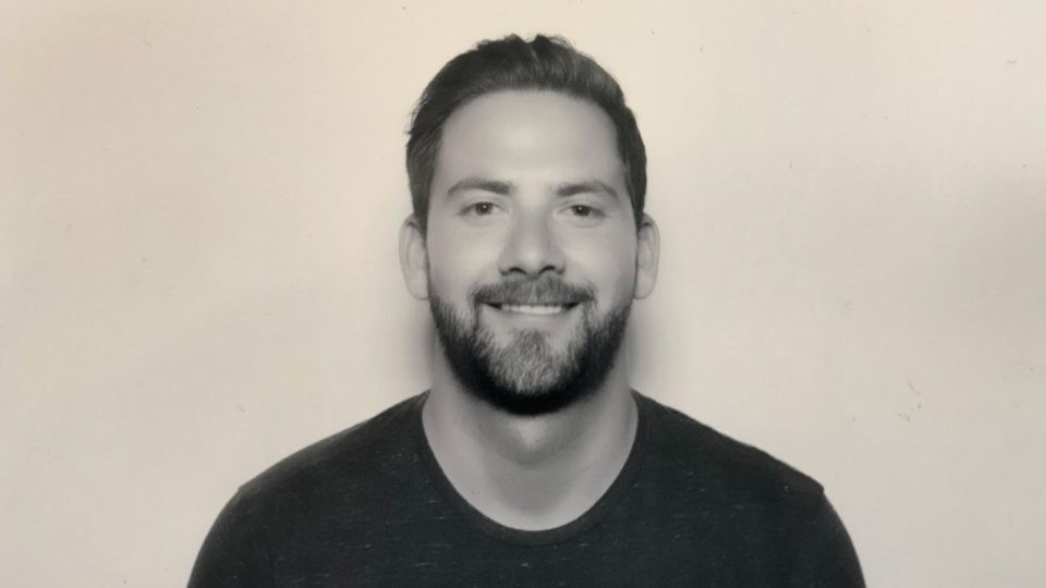 Headshot of Paul Muhlbach, an executive producer, smiling at the camera with a beard. Frame from Stash Magazine article.