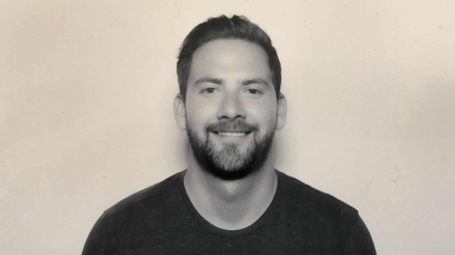 Headshot of Paul Muhlbach, an executive producer, smiling at the camera with a beard. Frame from Stash Magazine article.