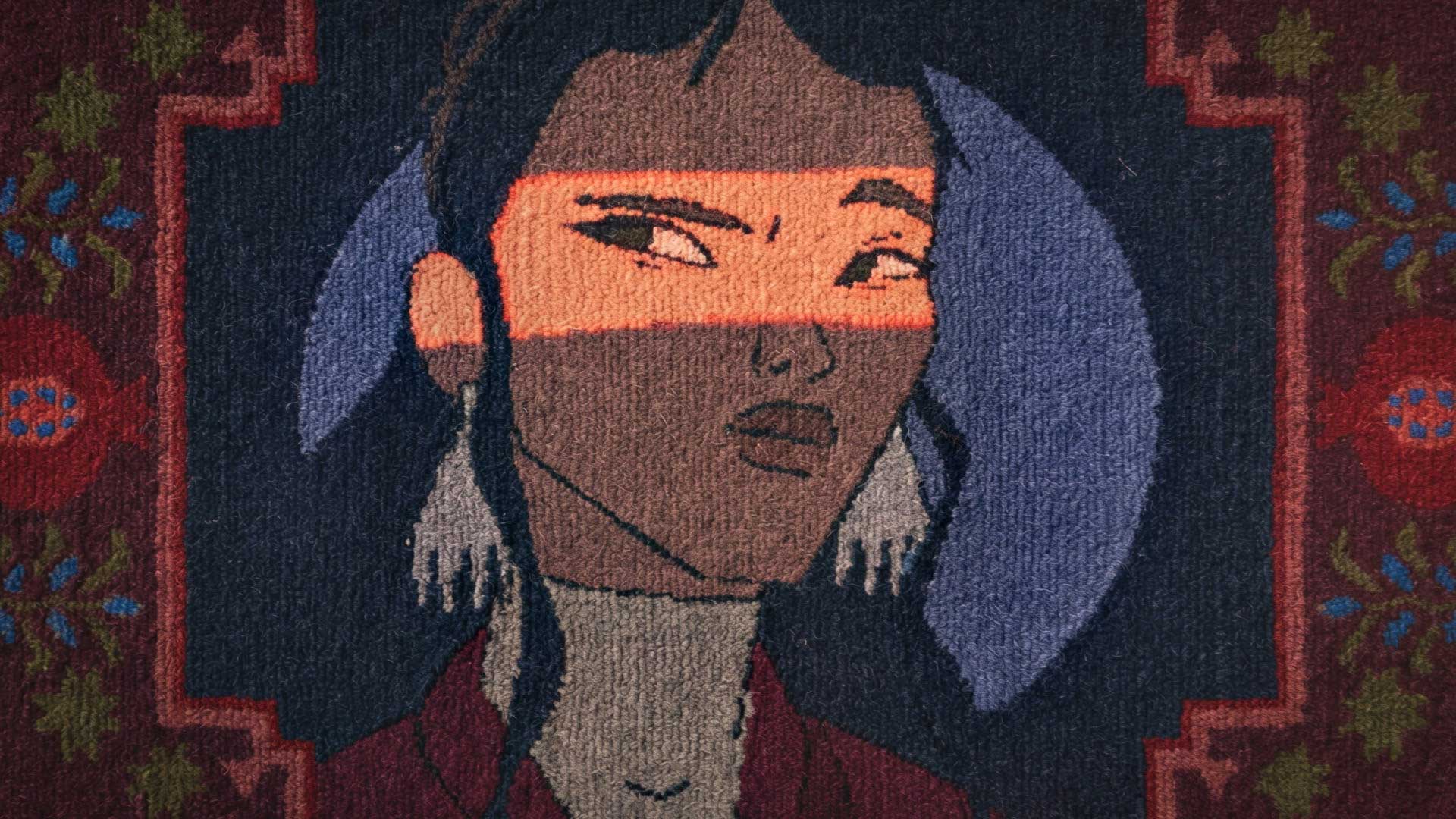 Textile art of a woman with large earrings and a high collar. A band of orange light crosses her eyes, adding a striking focal point. The dark background features floral and geometric patterns in red, green, and blue, reminiscent of the signature style seen when Petrick & Director Natalia Bazina roll out the carpet for WOSTOK. Frame from Stash Magazine article.