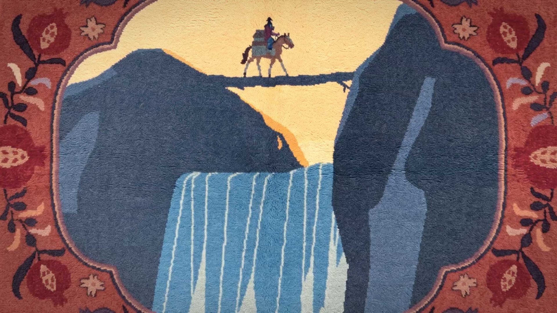 A person on horseback crosses a narrow bridge above a tall waterfall, framed by a decorative floral border in warm colors—a scene reminiscent of Natalia Bazina’s evocative designs for WOSTOK. Frame from Stash Magazine article.