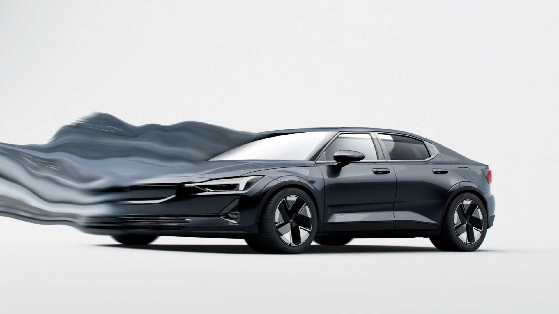 A dark blue Polestar sedan against a white background with a motion blur effect trailing from the front of the vehicle. Frame from Stash Magazine article.