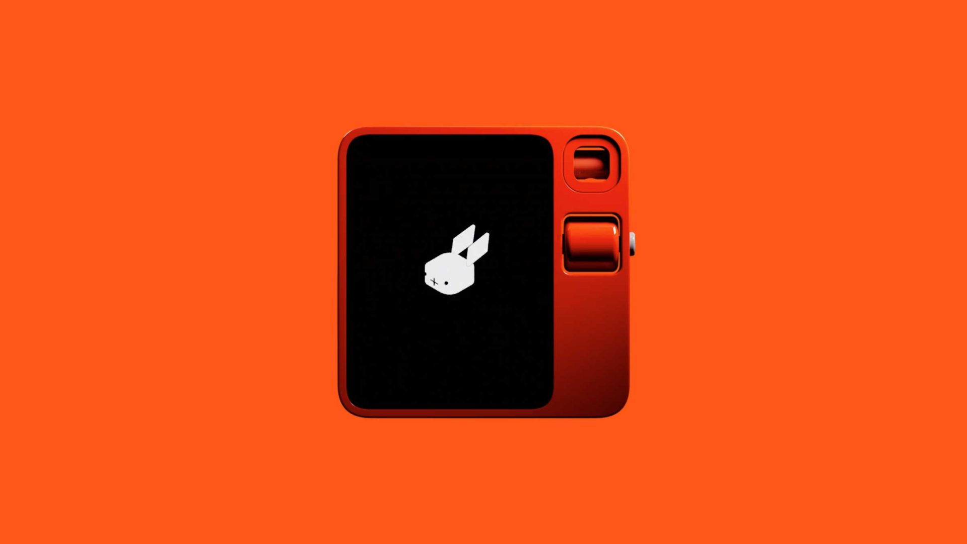 A small, red, square-shaped device with a black screen displaying a white bunny logo, set against a solid orange background. This Rabbit r1 product film by Styleframe GmbH highlights two buttons and a dial on the right side. Frame from Stash Magazine article.