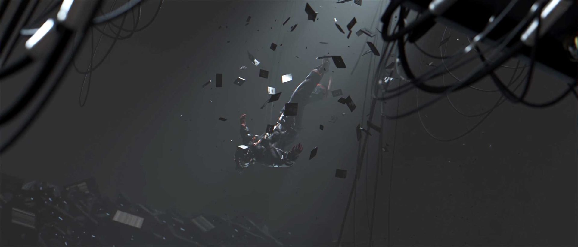 A person is floating in midair, surrounded by scattered metallic debris and cables in a dark, industrial environment—a haunting scene from Jeongmin Seo’s short film, “Reminder.”. Frame from Stash Magazine article.