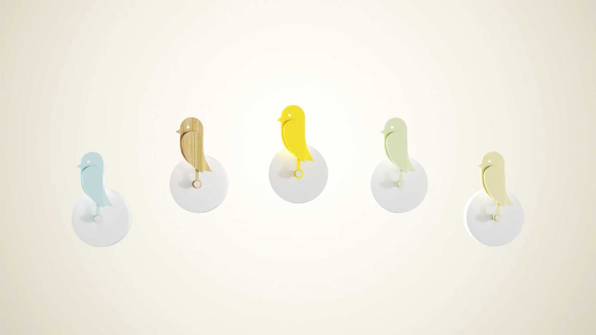 Four bird-shaped hooks from Birdie Brand Film in pastel blue, wood, yellow, and pastel green are mounted on round white bases against a light, neutral background—a subtle nod to Copenhagen design. Frame from Stash Magazine article.