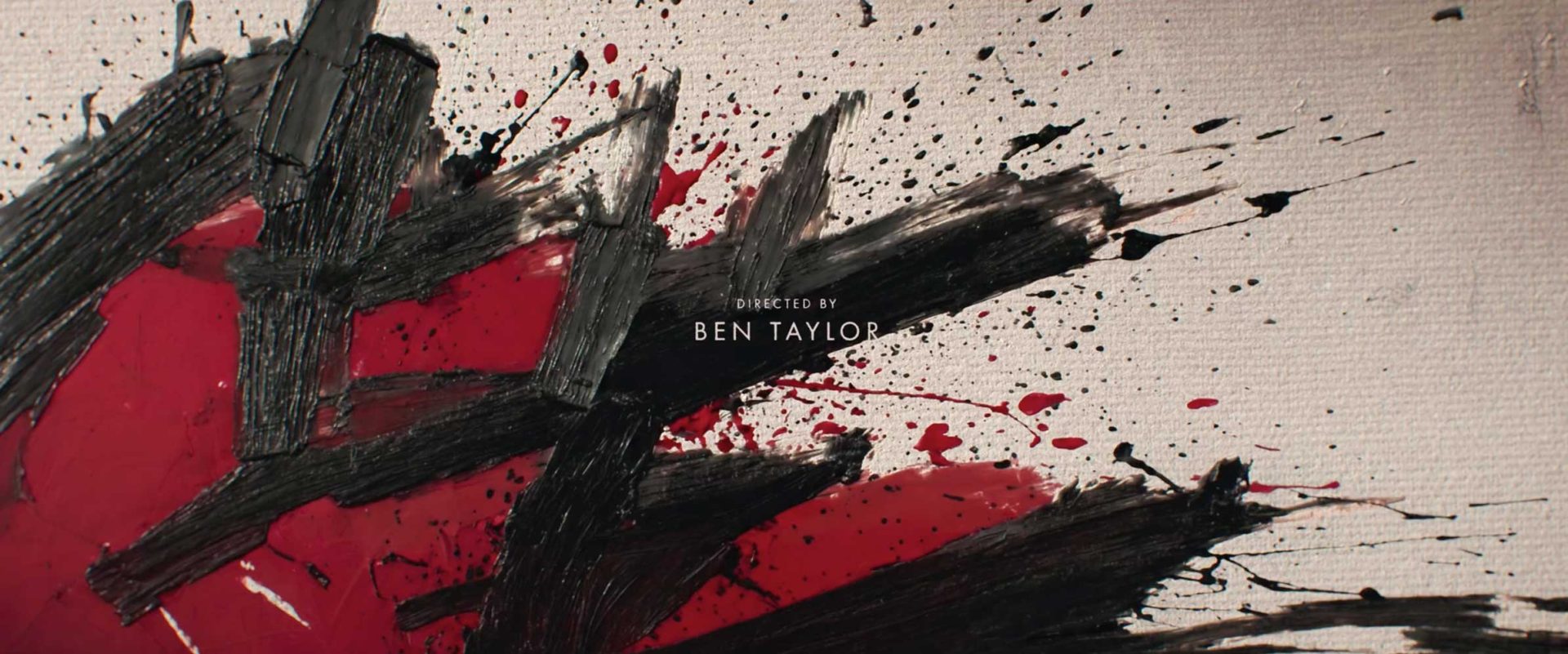 Abstract painting by Ronnie Koff with thick black brushstrokes and red paint splatters on a textured canvas, featuring the text Directed by Ben Taylor from the WAR HBO series. Frame from Stash Magazine article.