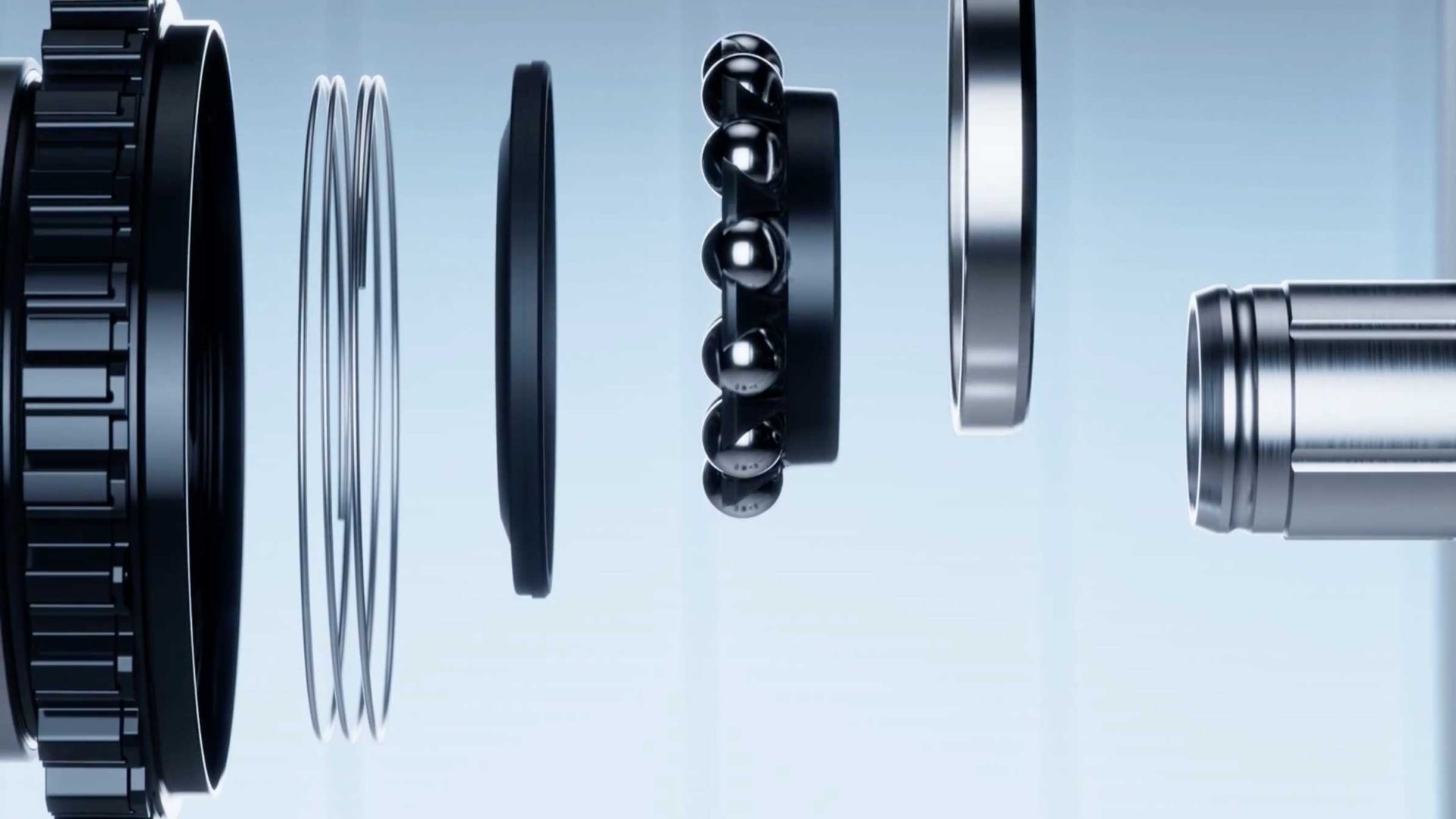 Exploded view of a ball bearing assembly, showing separate metal rings, balls, and other components aligned in a row on a light blue background, reminiscent of the precise engineering seen in Shimano DURA-ACE components. Frame from Stash Magazine article.