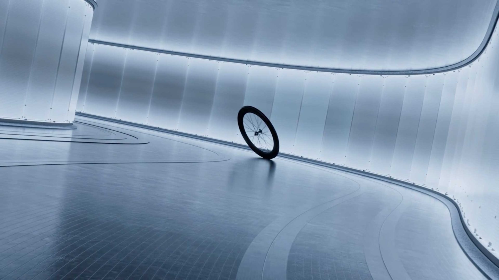 A single Shimano DURA-ACE bicycle wheel stands upright in a futuristic, curved, metallic hallway with reflective surfaces and soft, diffused lighting—a scene reminiscent of a stylish campaign film by Frame48. Frame from Stash Magazine article.