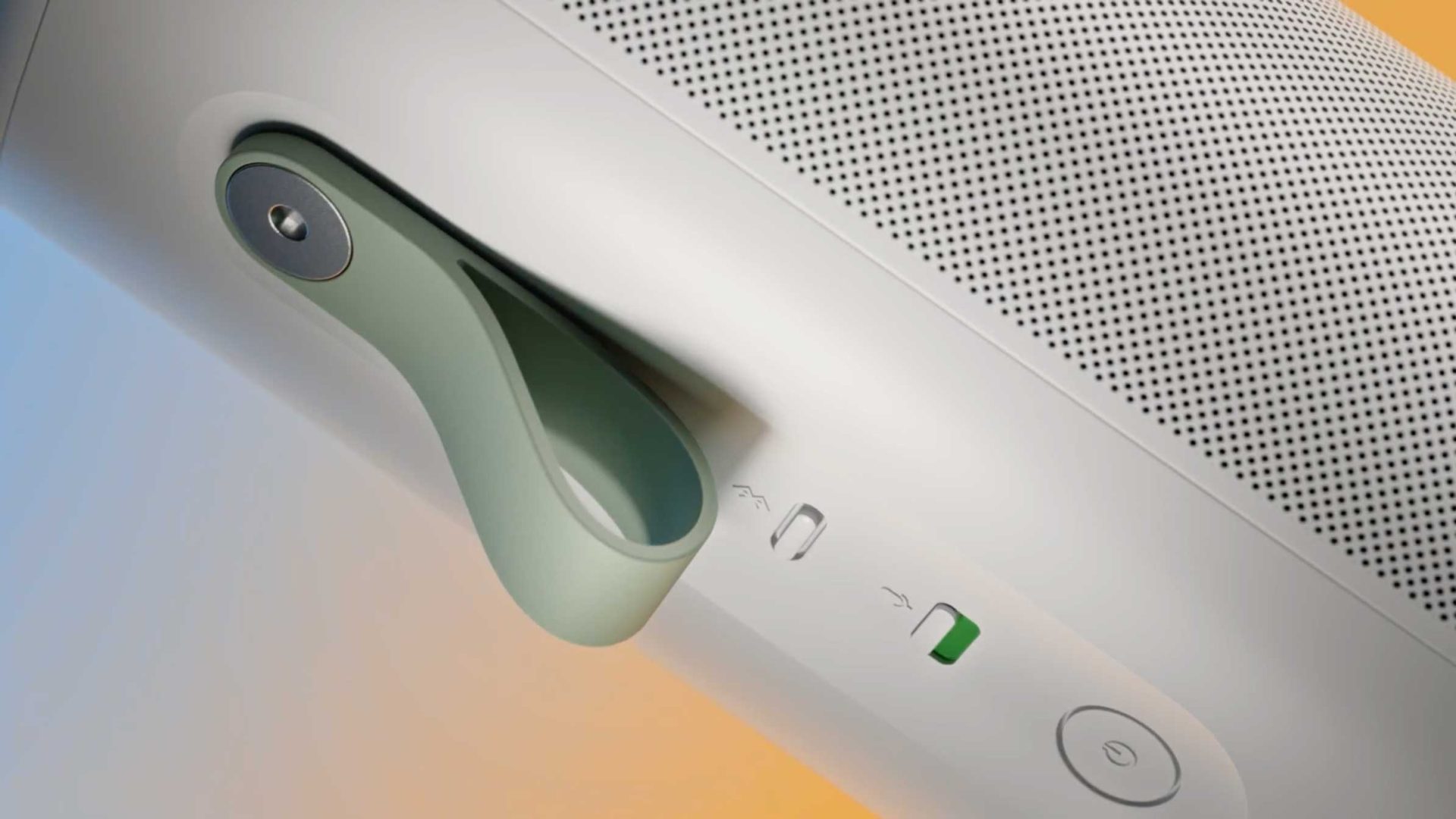 Close-up of a white portable Sonos speaker with a green rubber carrying loop, featuring a power button, Bluetooth button, and battery indicator on the side. The design was inspired by Play brand film visuals from Frame48. The grille is shown on top. Frame from Stash Magazine article.