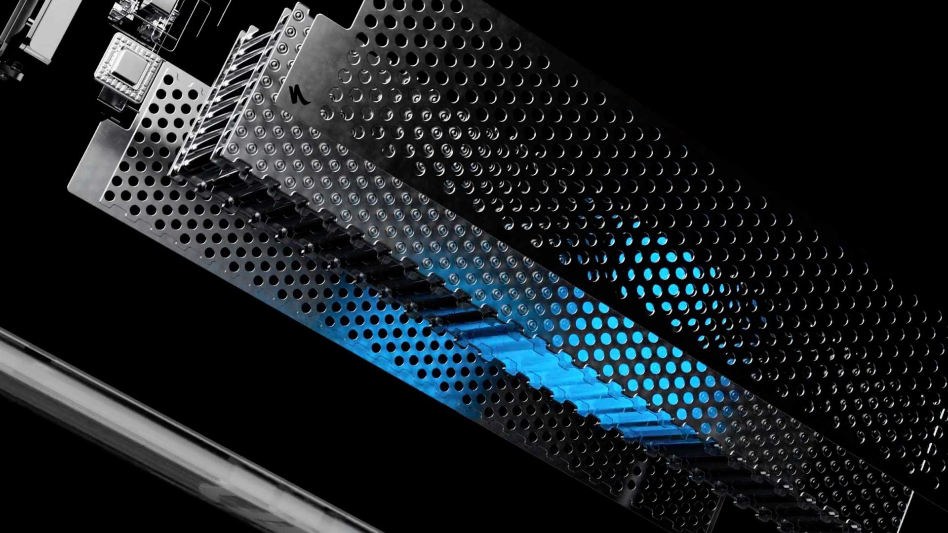 Close-up of a computer graphics card with a perforated metal cover, highlighted by a blue light glow shining through the holes, set against a black background—capturing the sense of inertia at launch that technology shares with innovations like the Specialized Vado 3. Frame from Stash Magazine article.