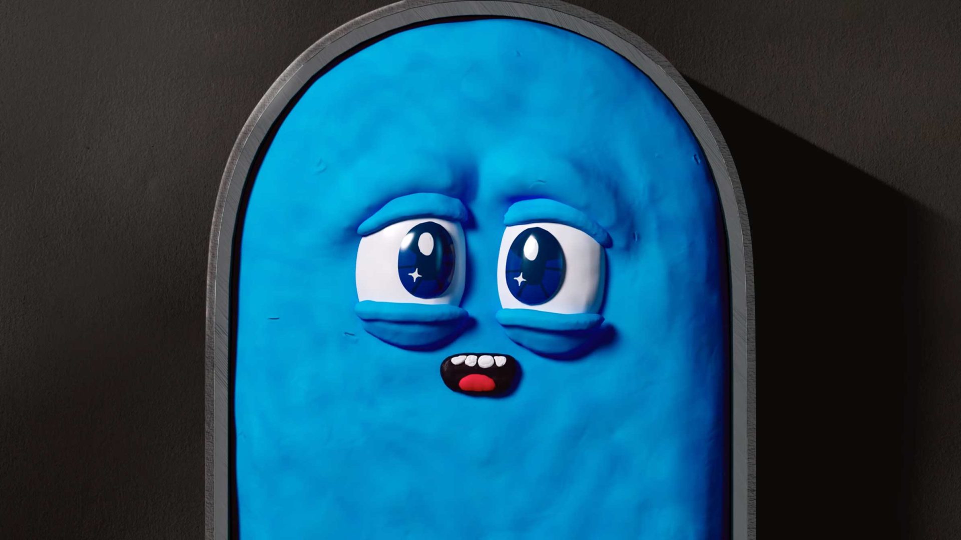 A blue, rounded rectangular cartoon character with big, shiny eyes and a small open mouth appears to be gazing in wonder—perhaps dreaming of Planet Super—set against a dark background. Frame from Stash Magazine article.