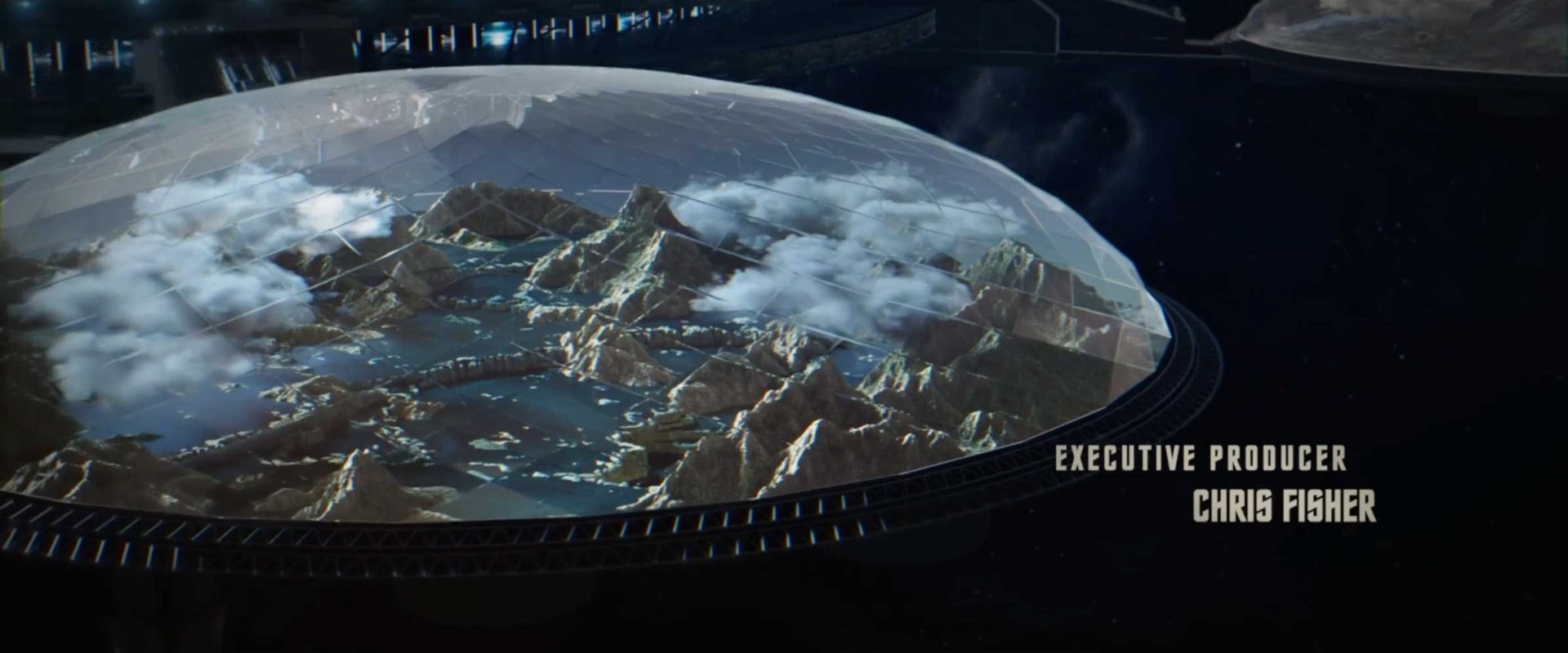A large glass dome covers a mountainous landscape with clouds, lakes, and a bridge, evoking the exploratory spirit of Star Trek: Strange New Worlds. Text on the right reads: EXECUTIVE PRODUCER CHRIS FISHER. Frame from Stash Magazine article.