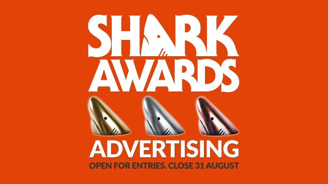Bold white text on an orange background reads Sharks Advertising 2026. Below are gold, silver, and bronze shark fin trophies. Text at the bottom says Open for entries. Close 31 August. Frame from Stash Magazine article.