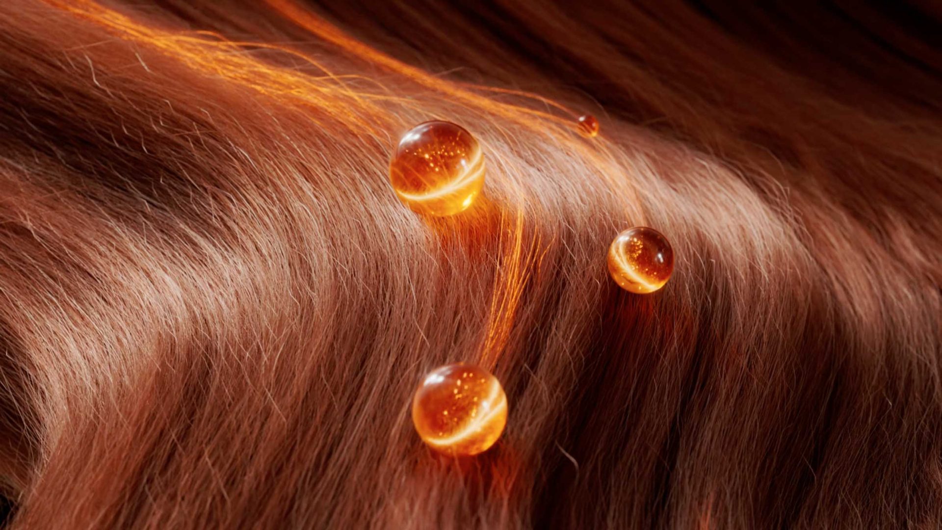 Close-up of smooth, shiny brown hair with three golden oil droplets resting on top, highlighting professional hair health and nourishment, styled to perfection by Reframe Studio with TRESemmé expertise. Frame from Stash Magazine article.