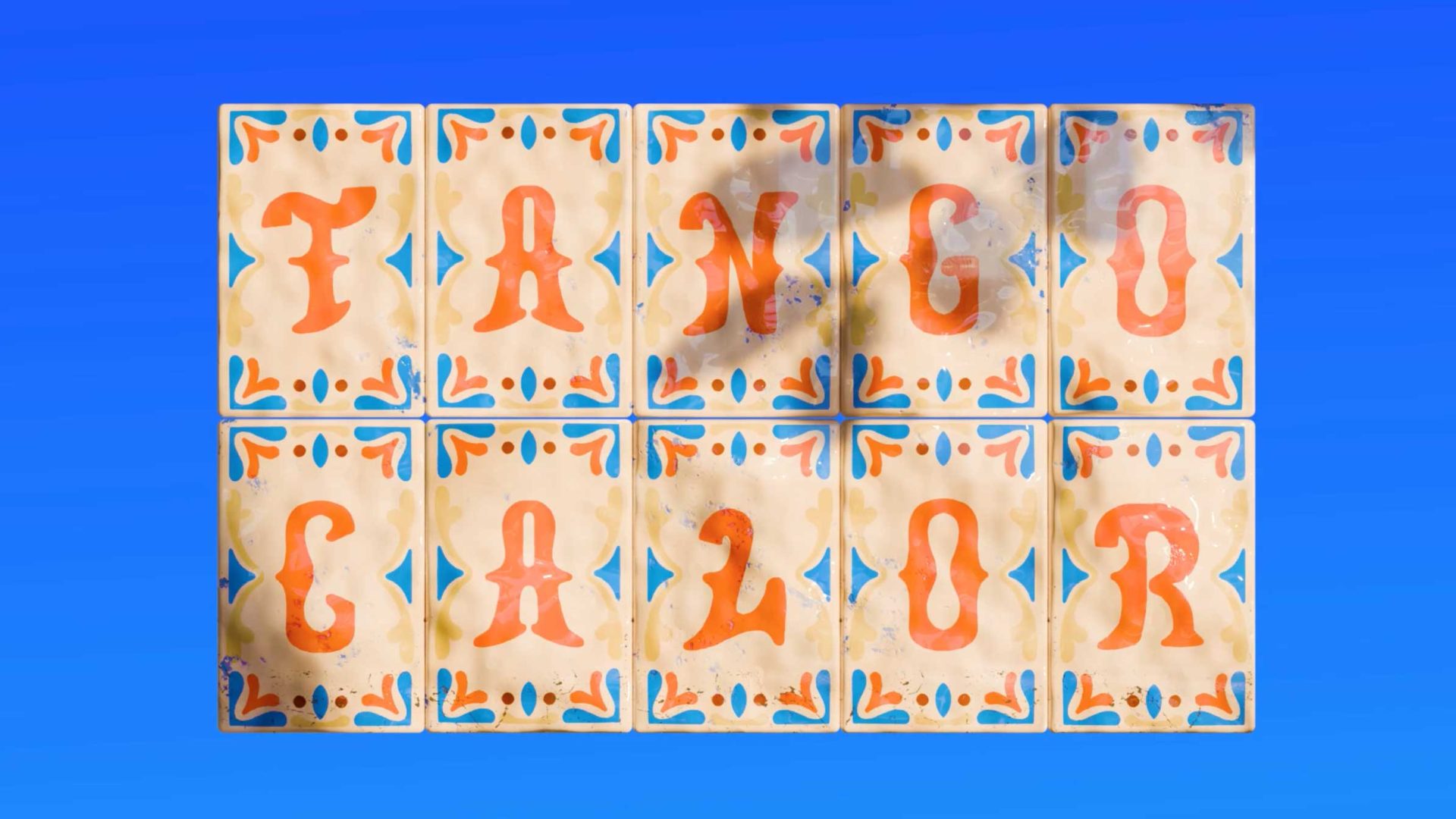 Decorative tiles spell out Tango Calor in bold orange letters against a blue background, with each letter on an individual tile surrounded by blue and red patterns—an eye-catching visual sure to stand out in any short film produced by Rocketpanda. Frame from Stash Magazine article.