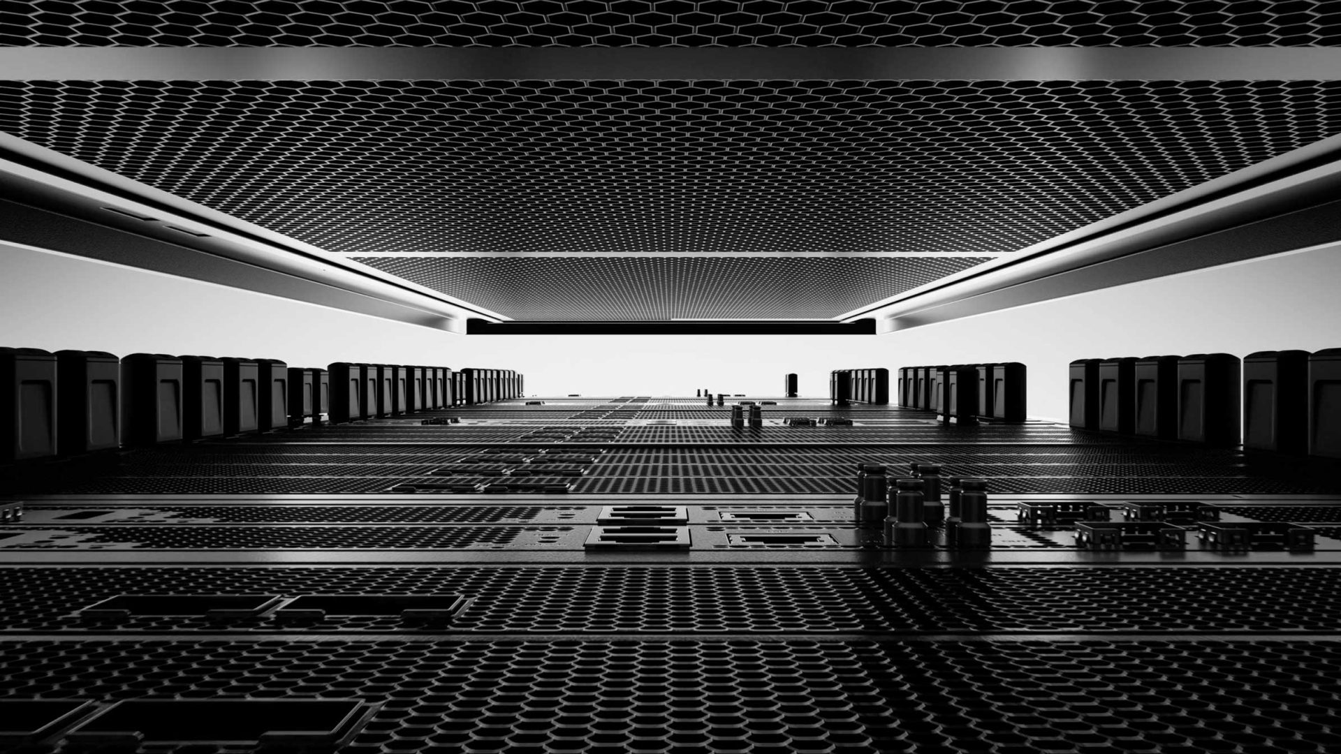 Close-up, low-angle view of a futuristic, black computer server or Tensordyne data center interior with geometric patterns, metallic textures, and illuminated ceiling panels creating a high-tech, symmetrical atmosphere. Frame from Stash Magazine article.