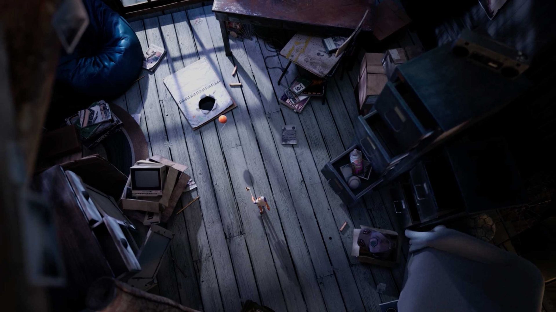 A tiny figure from the short film Together stands on a cluttered wooden floor, reaching up toward a small orange ball floating in the air. Frame from Stash Magazine article.