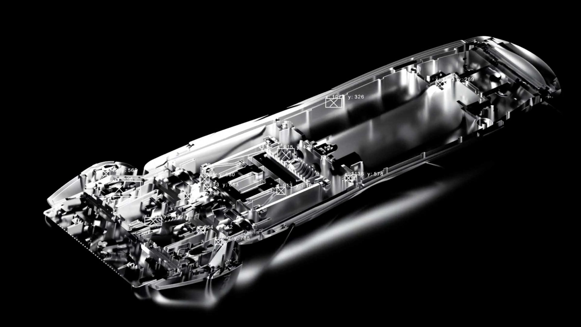 A shiny, metallic chassis or frame of a car is shown on a black background, echoing the abstract, futuristic style of a Trench Studio Braun Series 7 spec product film by highlighting detailed, intricate interior structure and components. Frame from Stash Magazine article.
