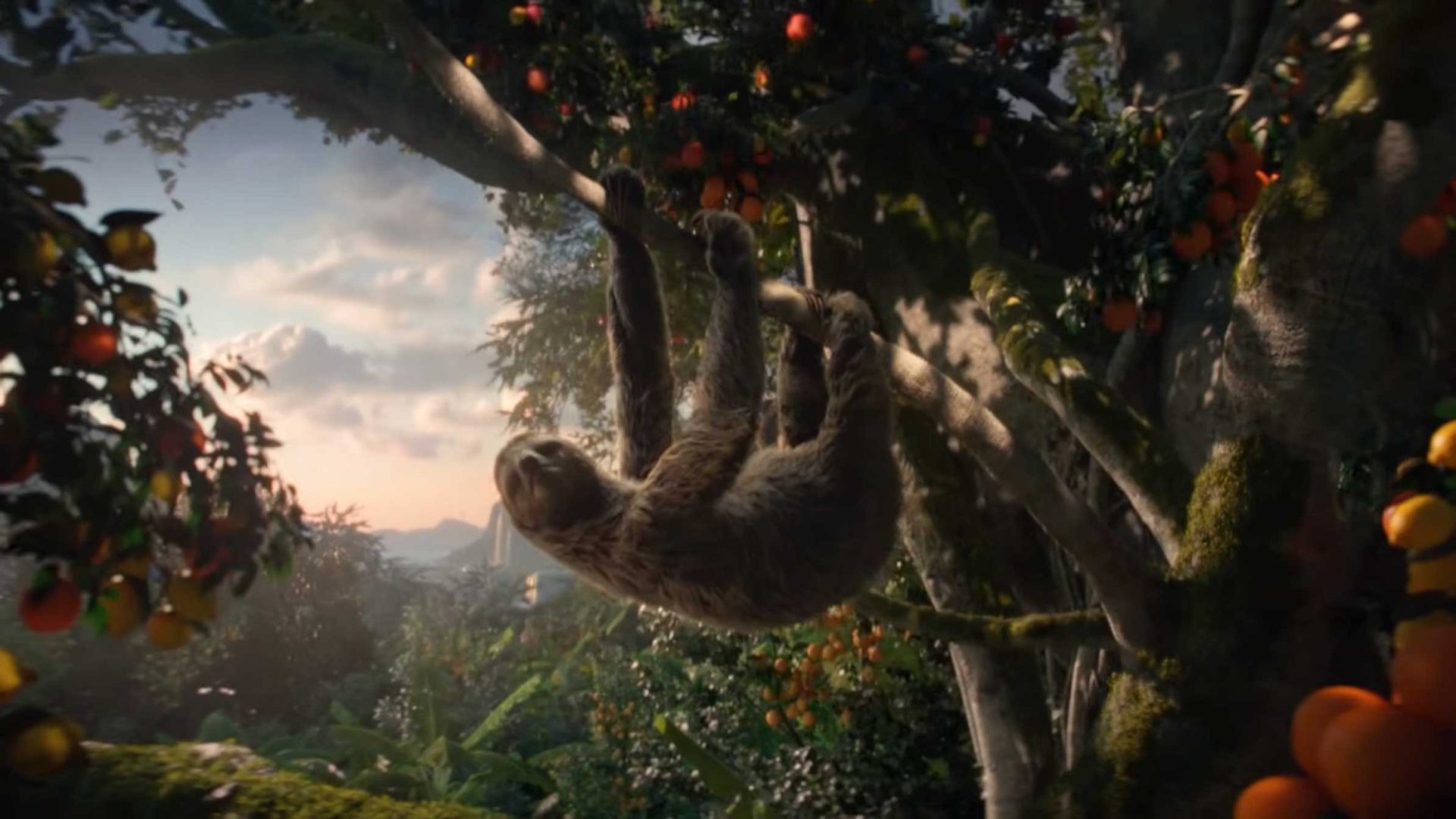 A sloth hangs upside down from a tree branch in a lush, vibrant jungle filled with green foliage and orange fruits, basking in a soft Tropicana sunset sky—an untold scene full of natural beauty. Frame from Stash Magazine article.
