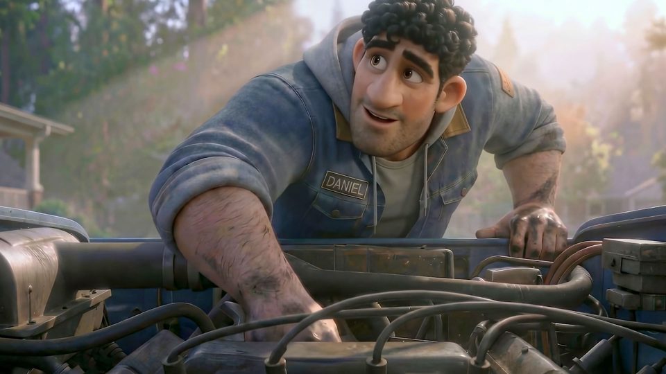 A smiling animated man with curly dark hair and a stubbly beard, wearing a blue denim jacket labeled Daniel, works under the hood of a vehicle outdoors in daylight—like putting his heart out to dry after laundry day. Frame from Stash Magazine article.