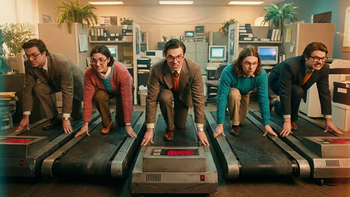 Five people in business attire crouch in a starting position on treadmills amid desks and paperwork—a Necessary Mess that chronicles the intense, competitive atmosphere of office life, where pitching ideas is part of the daily race. Frame from Stash Magazine article.