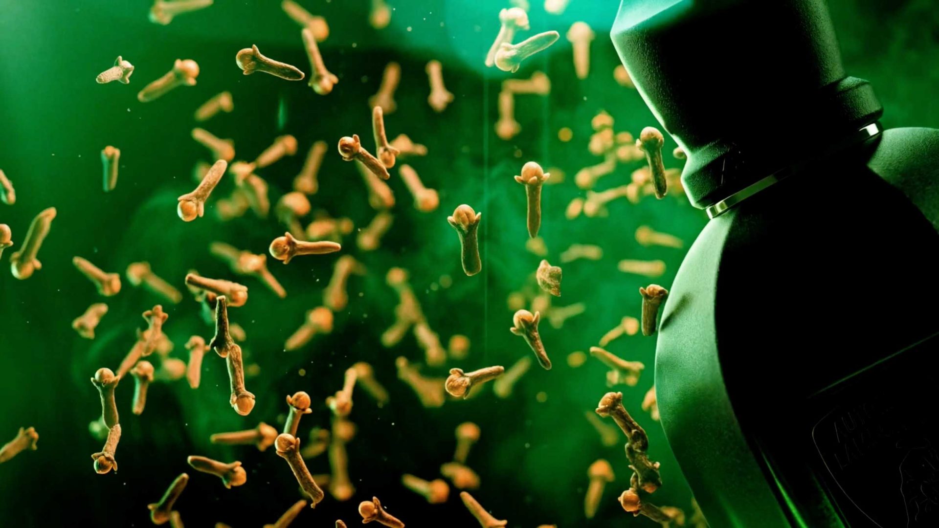 A bottle, styled with Nerdo Studio’s sleek design, releases swirling germs or bacteria—depicted as small organisms—into a green background, suggesting a cleaning or disinfecting theme. Frame from Stash Magazine article.